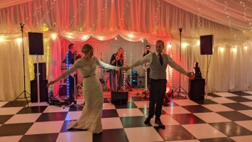 Bride and groom on a black & white dancefloor