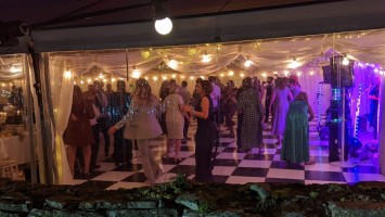 Panoramic windows in a clearspan marquee and black and white dance floor