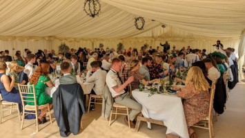 Lined internal clearspan with banqueting tables and Lime washed Chairs