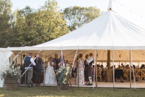 Traditional canvas marquee at a wedding with Oak Cross Back chairs.