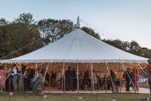 Traditional marquee at dusk with festoon lighting.