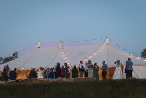 Traditional marquee at dusk with festoon lighting at country wedding